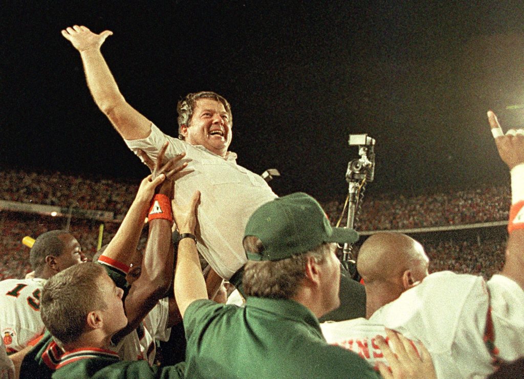 ** FILE ** University of Miami coach Jimmy Johnson is carried from the field by his players after the Hurricanes defeated the Oklahoma 20-14 in the Orange Bowl Classic in Miami, in this Jan. 1, 1988 file photo. (AP Photo/Raul Demolina) ORG XMIT: NY210